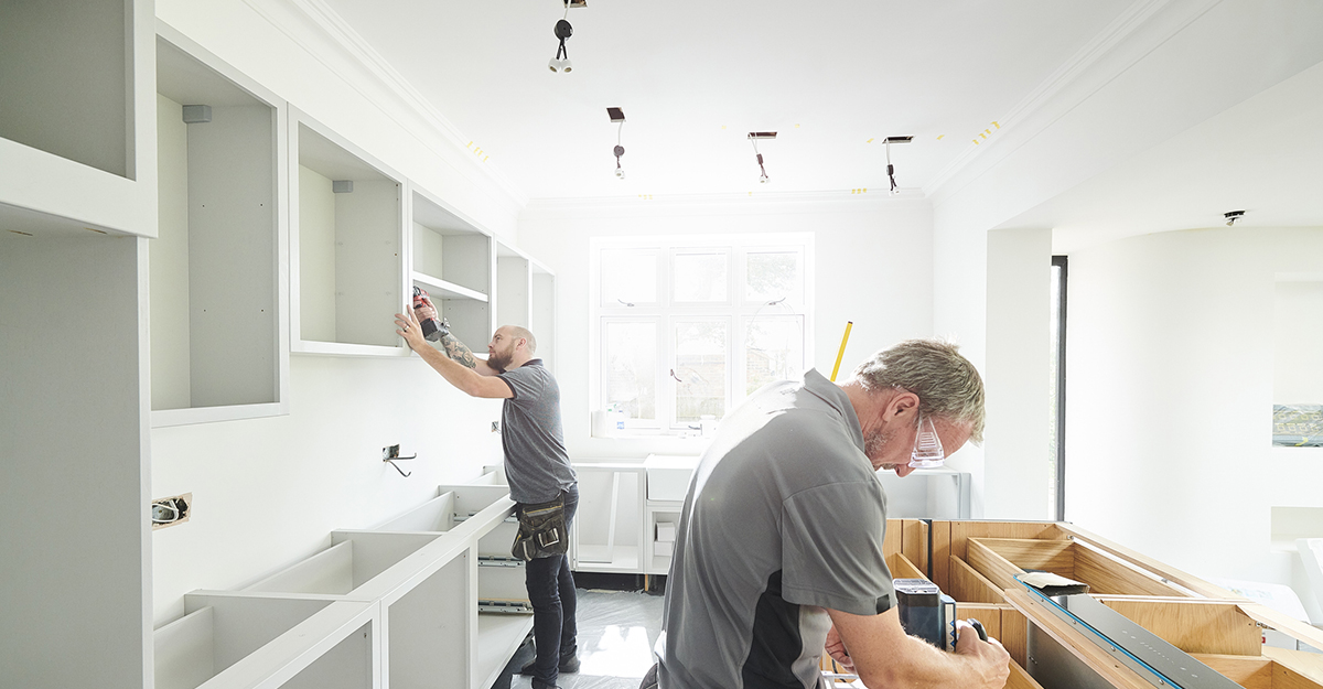 Two construction workers remodeling a home