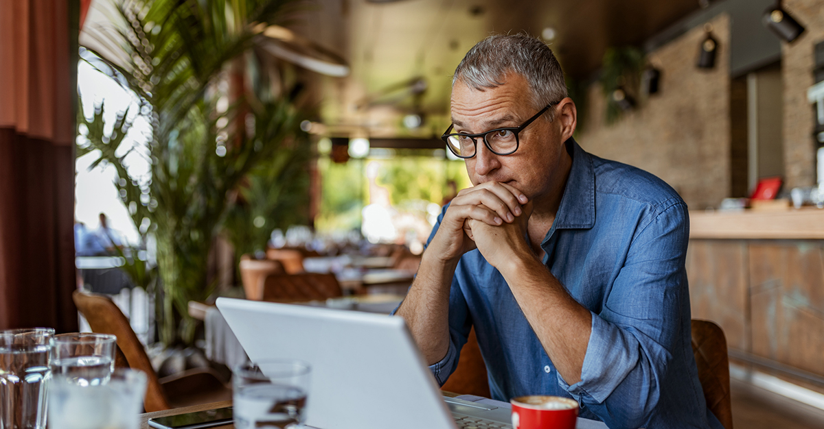 A man on laptop concerned about cybersecurity