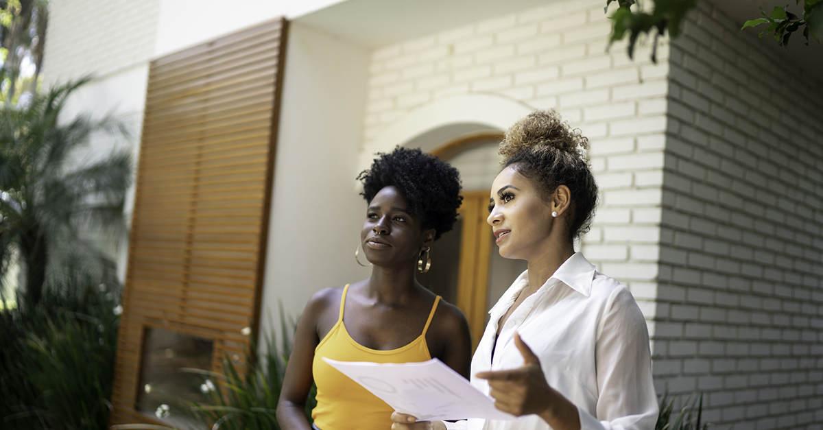 An agent meeting with a client at a home