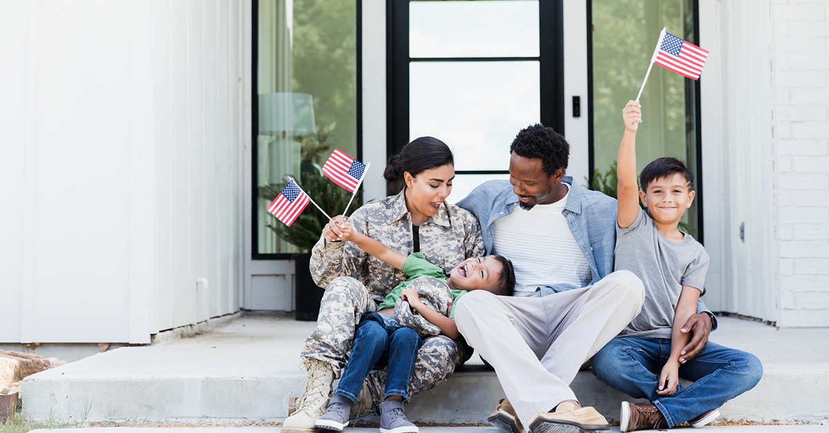 Military family sits on their front porch.