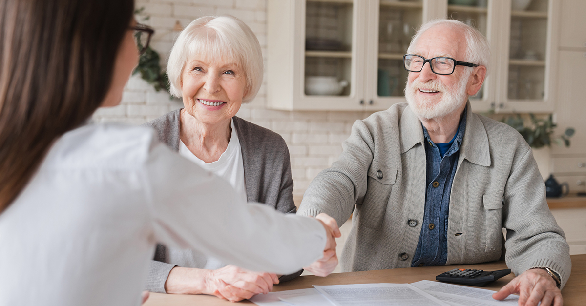 An elderly couple meets with a financial advisor